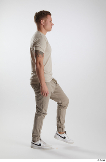 Gilbert 1 dressed grey t-shirt grey trousers side view walking…